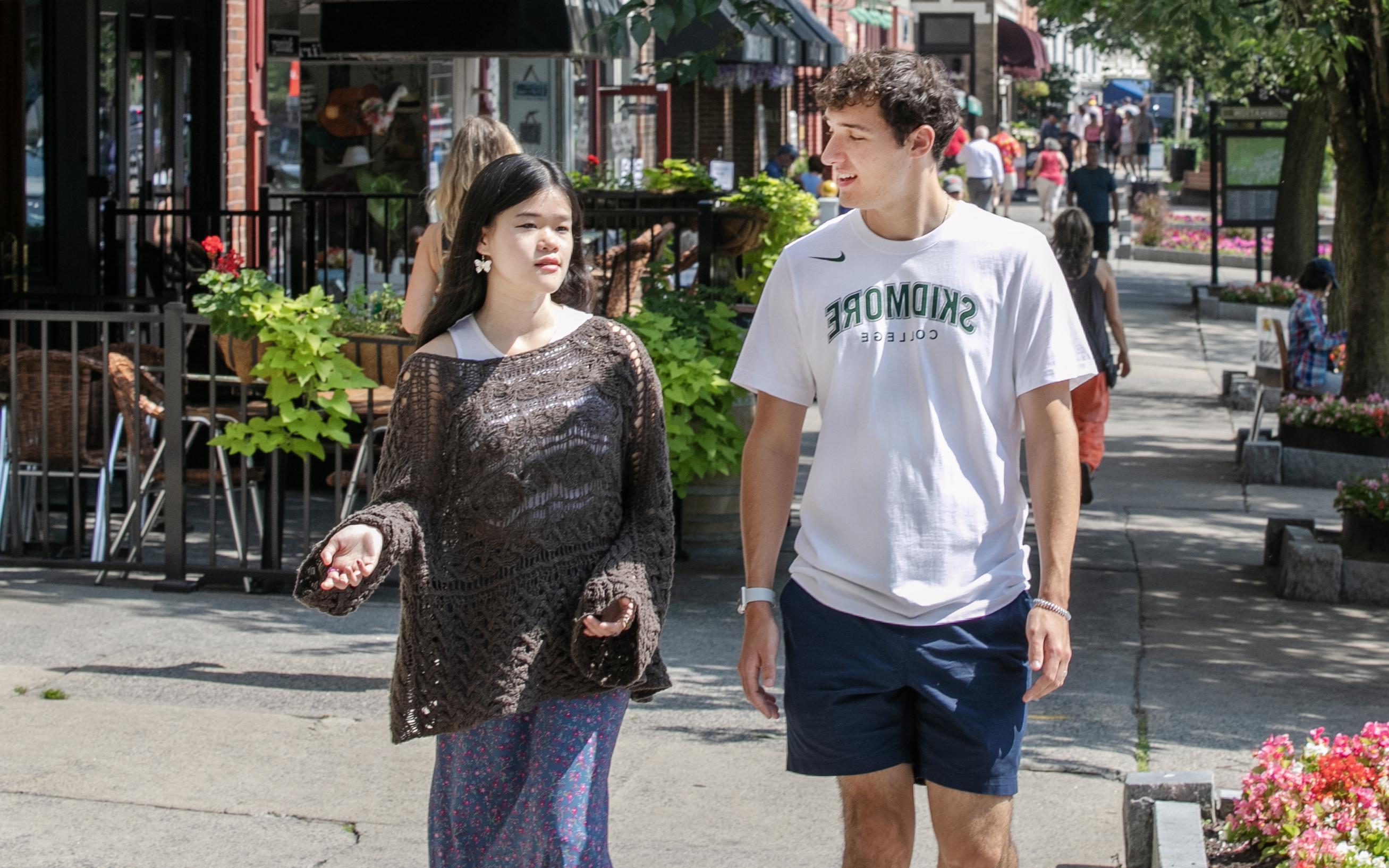 Two students walk down Broadway.