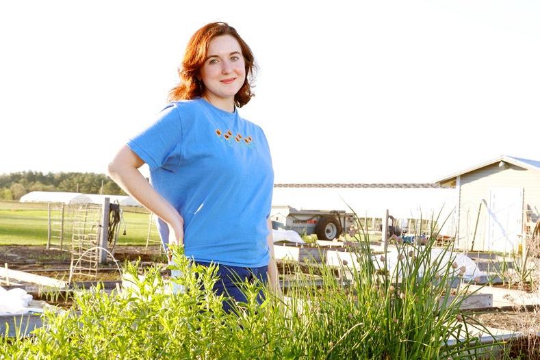 young+woman+standing+in+farm+field