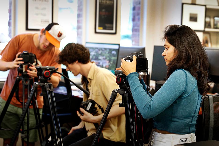 Three+students+work+in+the+DOCLab+with+camera+equipment+during+a+documentary+studies+course+in+fall+2022.